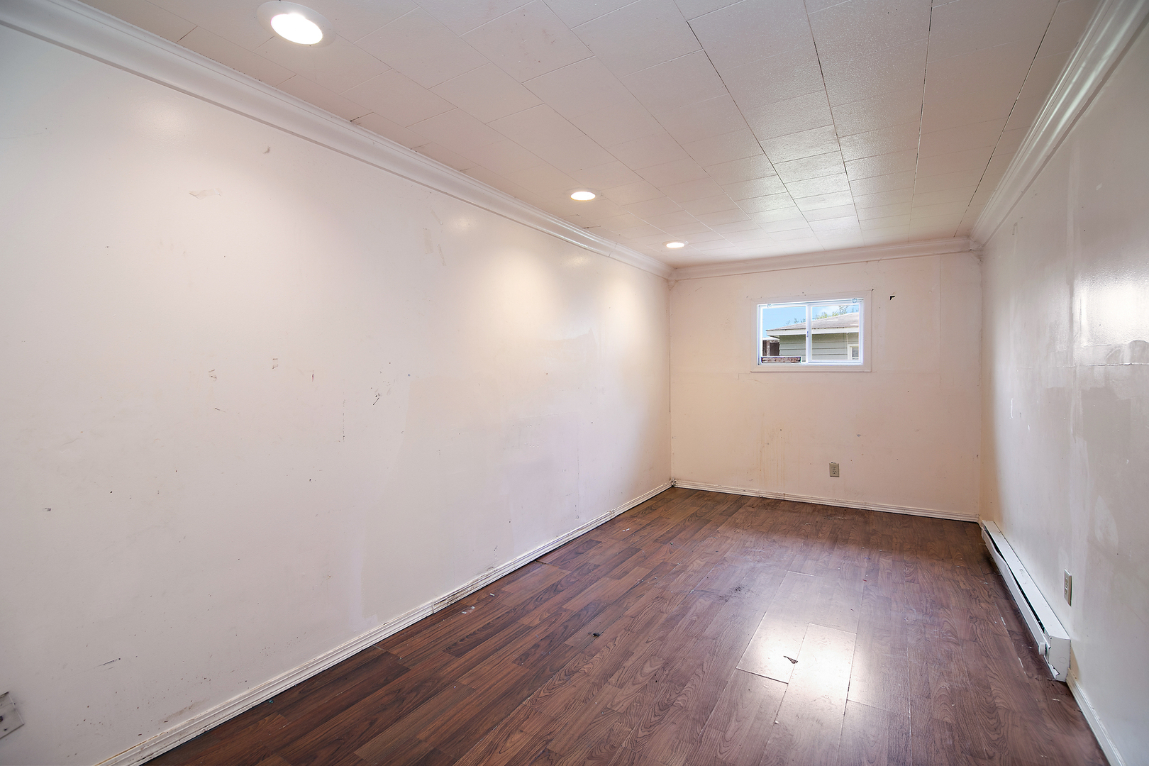 1990 Patrick Avenue Kankakee, IL 60901 - Photo 4 of 15 an empty room with wooden floor and windows