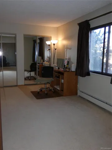 a view of a livingroom with furniture and a flat screen tv