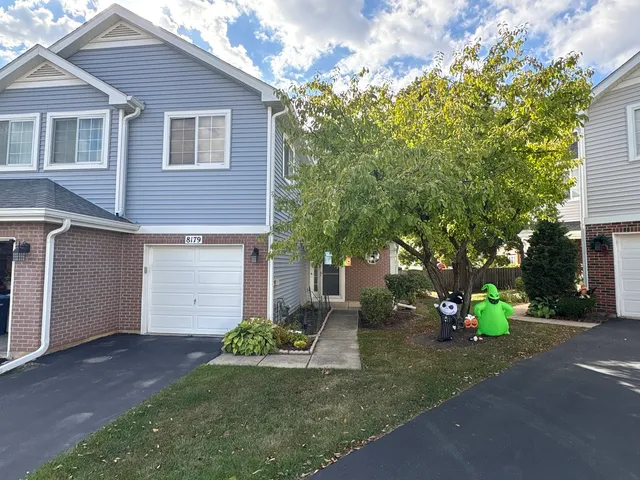 a front view of a house with a yard and a garage