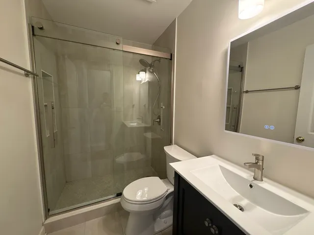 a bathroom with a sink toilet and shower