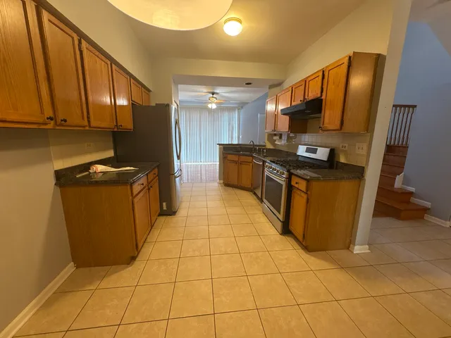 a kitchen with stainless steel appliances a stove a sink and a microwave