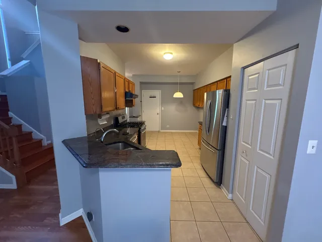 a kitchen with refrigerator and window