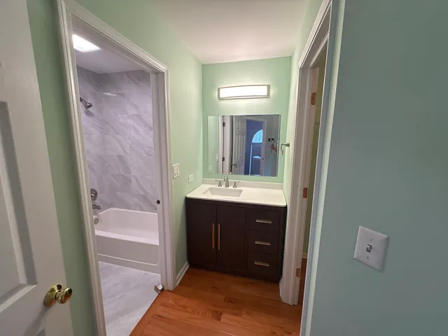 a bathroom with a sink a mirror and a bathtub