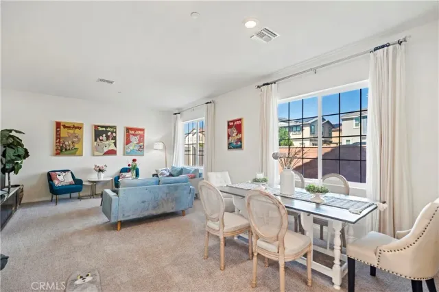 a living room with fireplace furniture and a large window