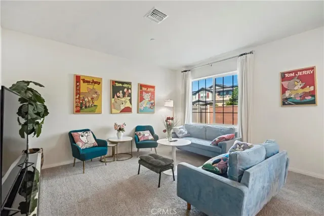 a living room with furniture and a potted plant