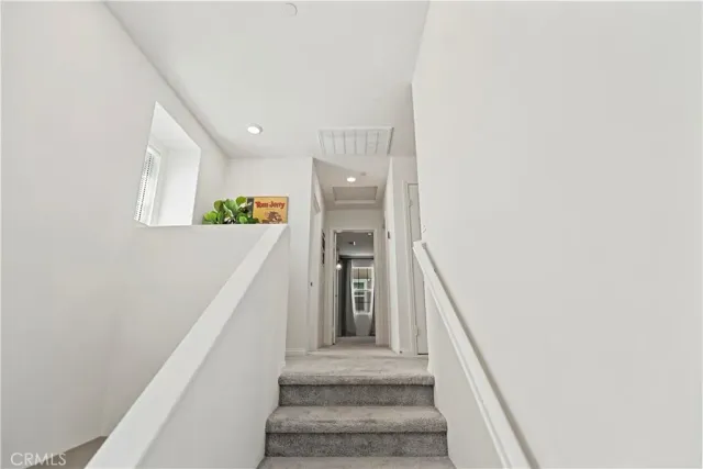 a view of a hallway with paintings on the wall