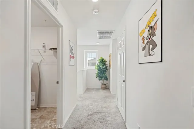 a bedroom with two beds and dresser