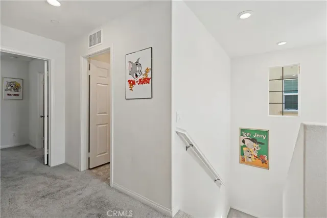 a bathroom with a sink vanity mirror and toilet