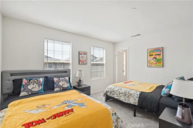 a bedroom with two beds and a window