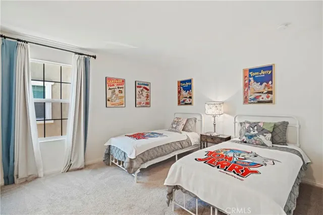 a bedroom with a bed a couch and a window