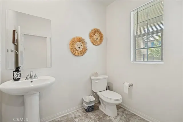 a bathroom with a toilet sink and vanity