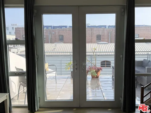 a spacious bedroom with a bed and a large window