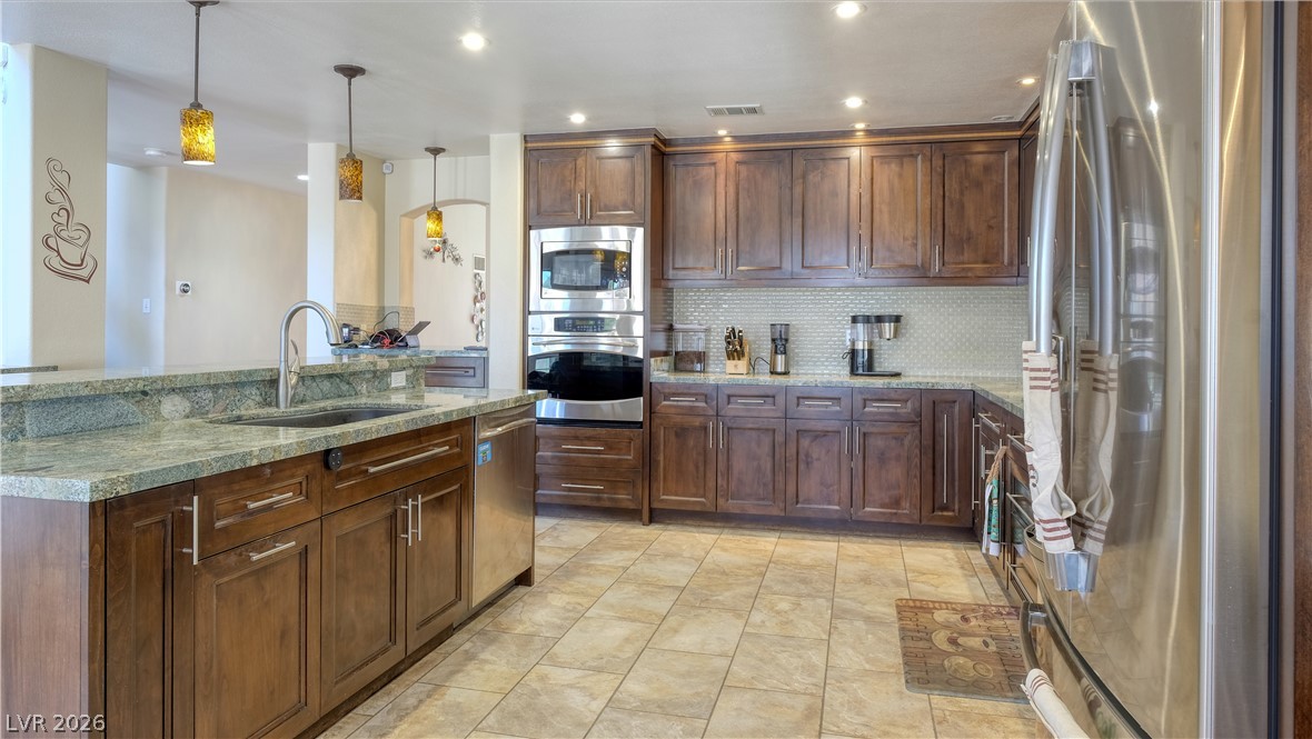 3704 North Campbell Road Las Vegas, NV 89129 - Photo 3 of 46 Culinary delights await in this spacious kitchen, boasting stainless steel appliances and ample counter space.