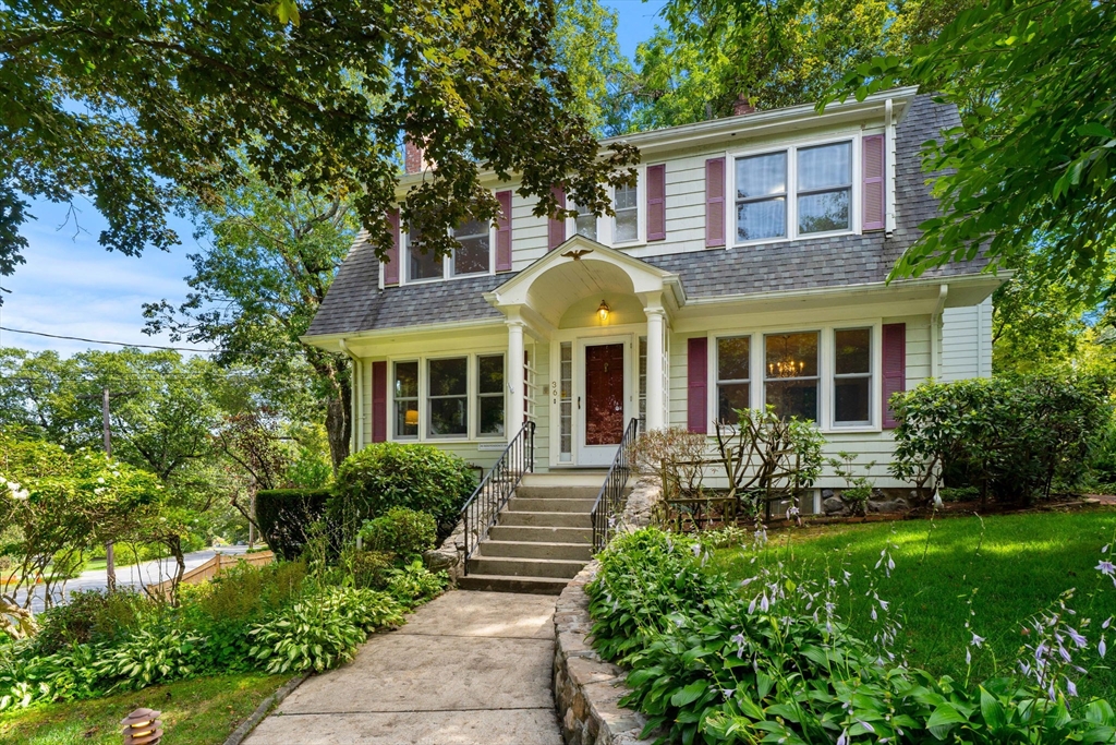 a front view of a house with garden and porch