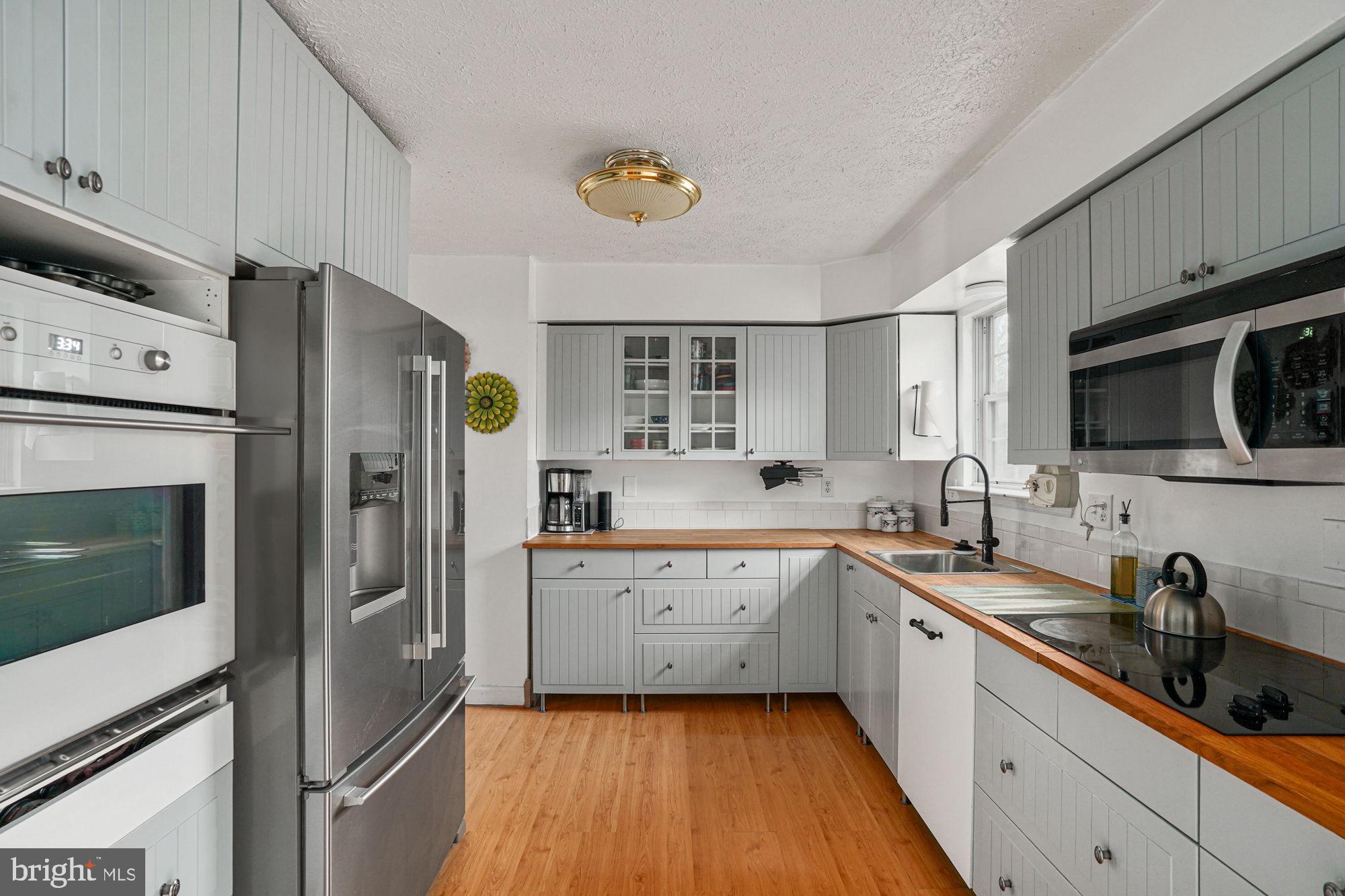 38 Buck Road Stafford, VA 22556 - Photo 11 of 39 a kitchen with stainless steel appliances a sink cabinets and a refrigerator