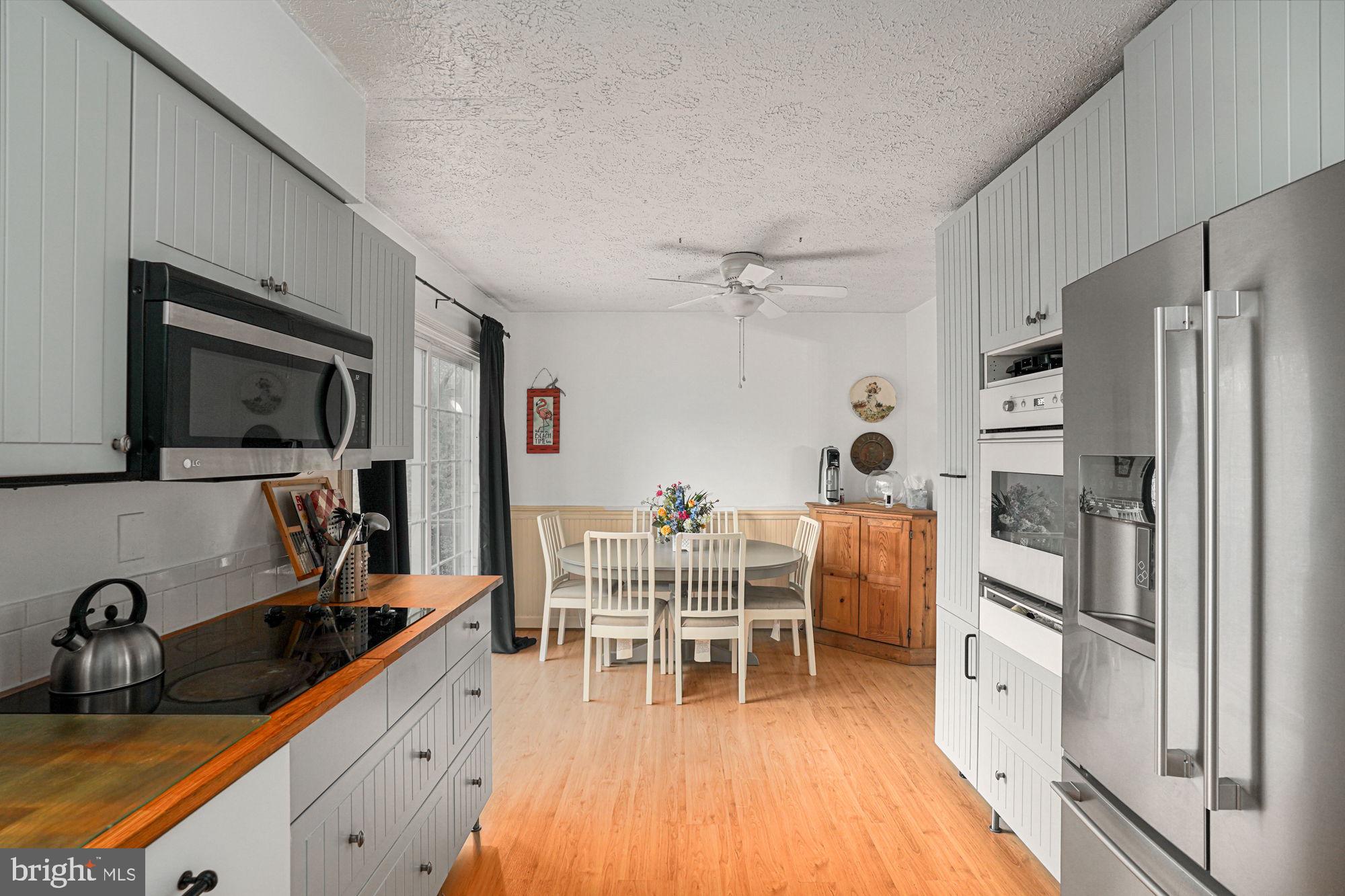 38 Buck Road Stafford, VA 22556 - Photo 14 of 39 a kitchen with stainless steel appliances a stove a sink and a refrigerator