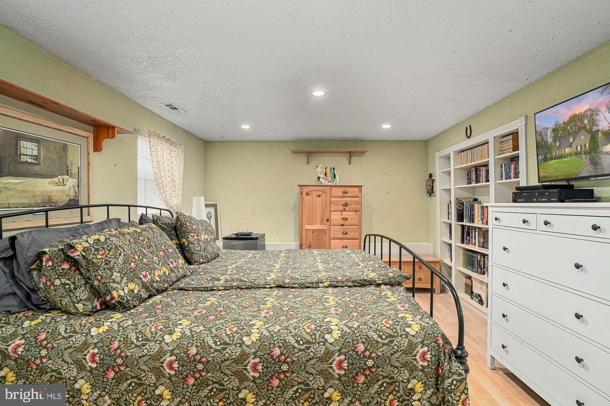 38 Buck Road Stafford, VA 22556 - Photo 24 of 39 a large bedroom with a bed and flat screen tv