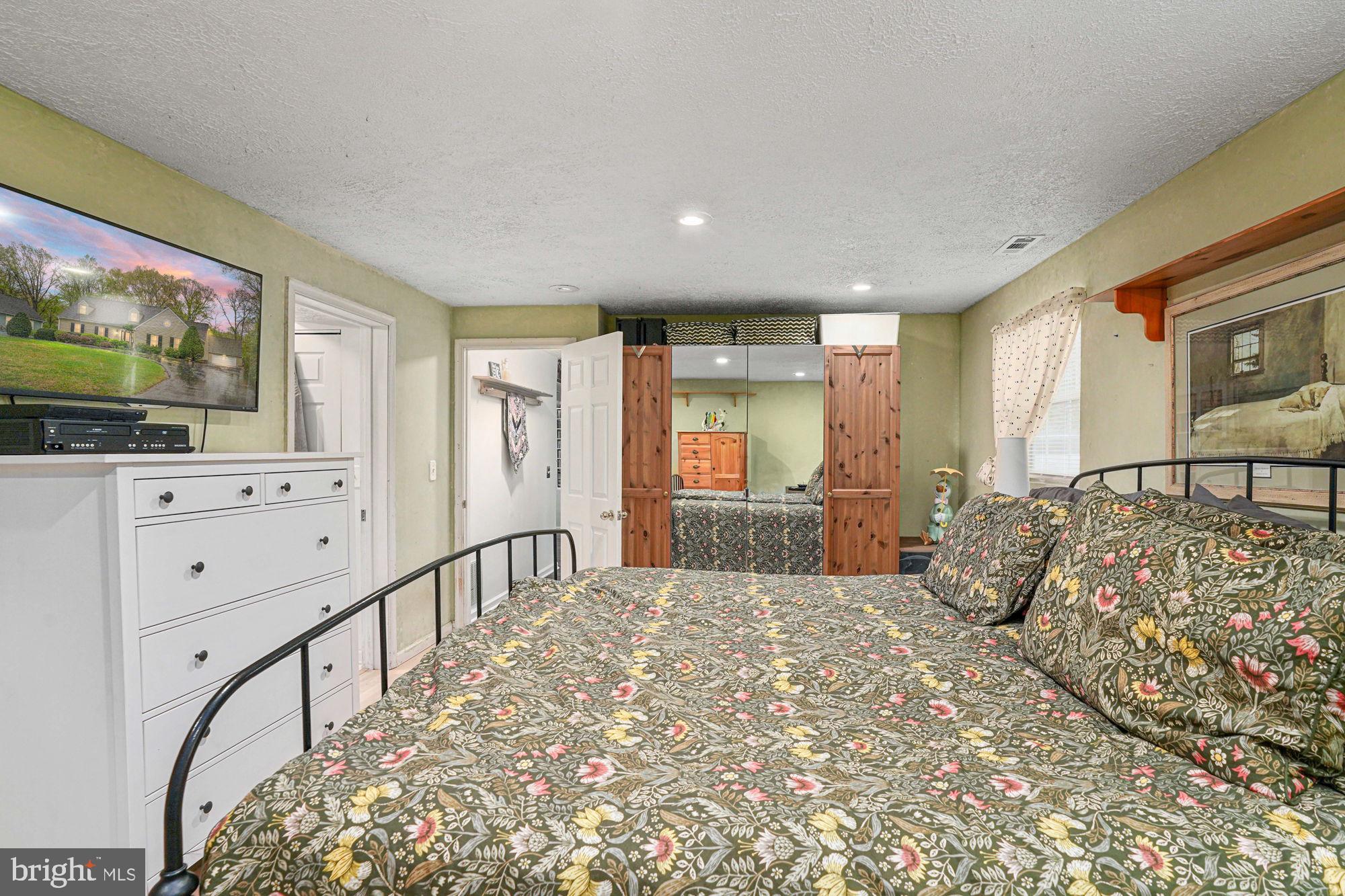 38 Buck Road Stafford, VA 22556 - Photo 25 of 39 a spacious bedroom with a large bed and a flat tv screen on dresser