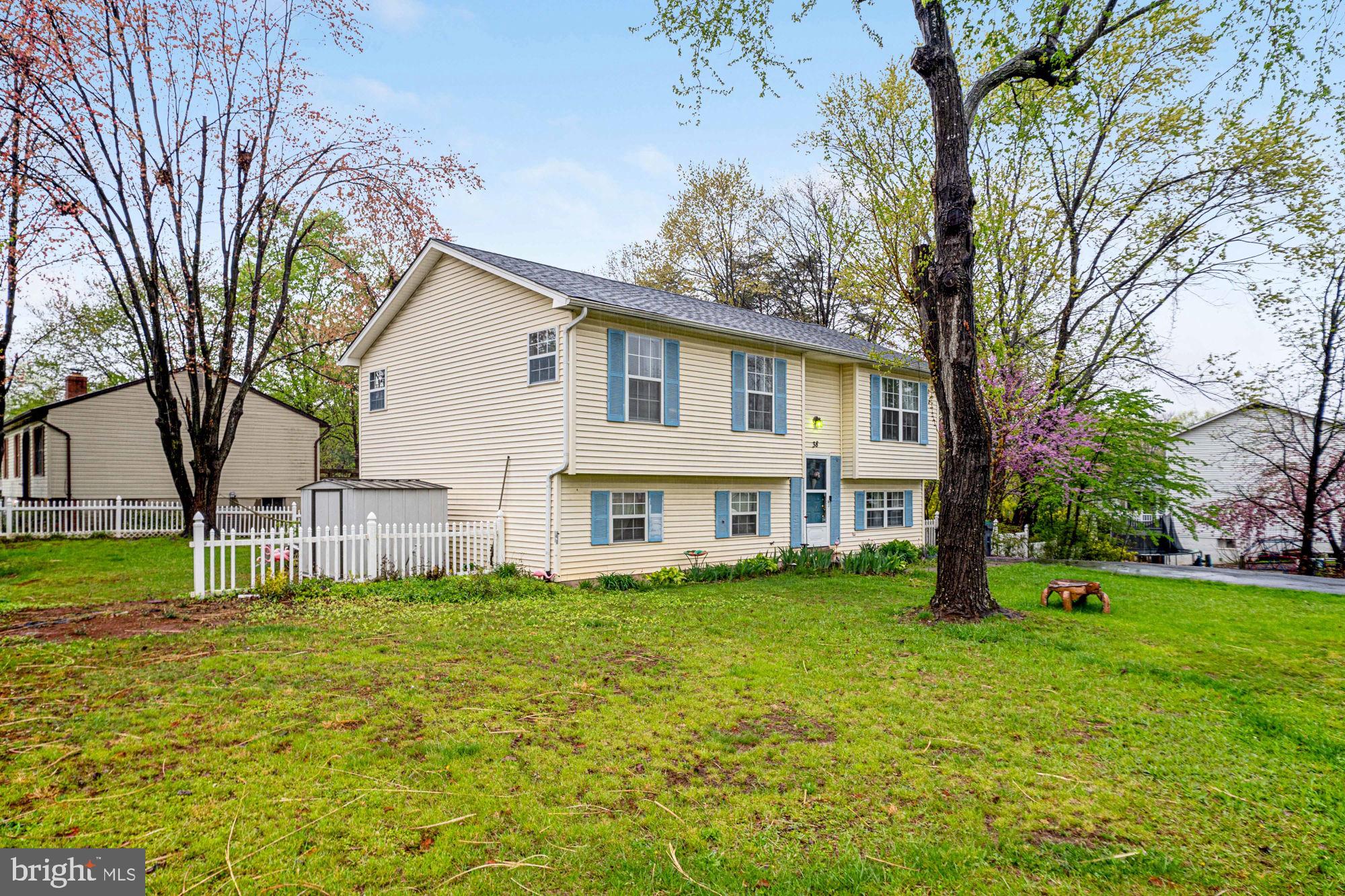 38 Buck Road Stafford, VA 22556 - Photo 32 of 39 a white house with a large tree and yard