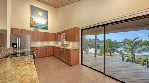 a bathroom with a glass shower door and a window