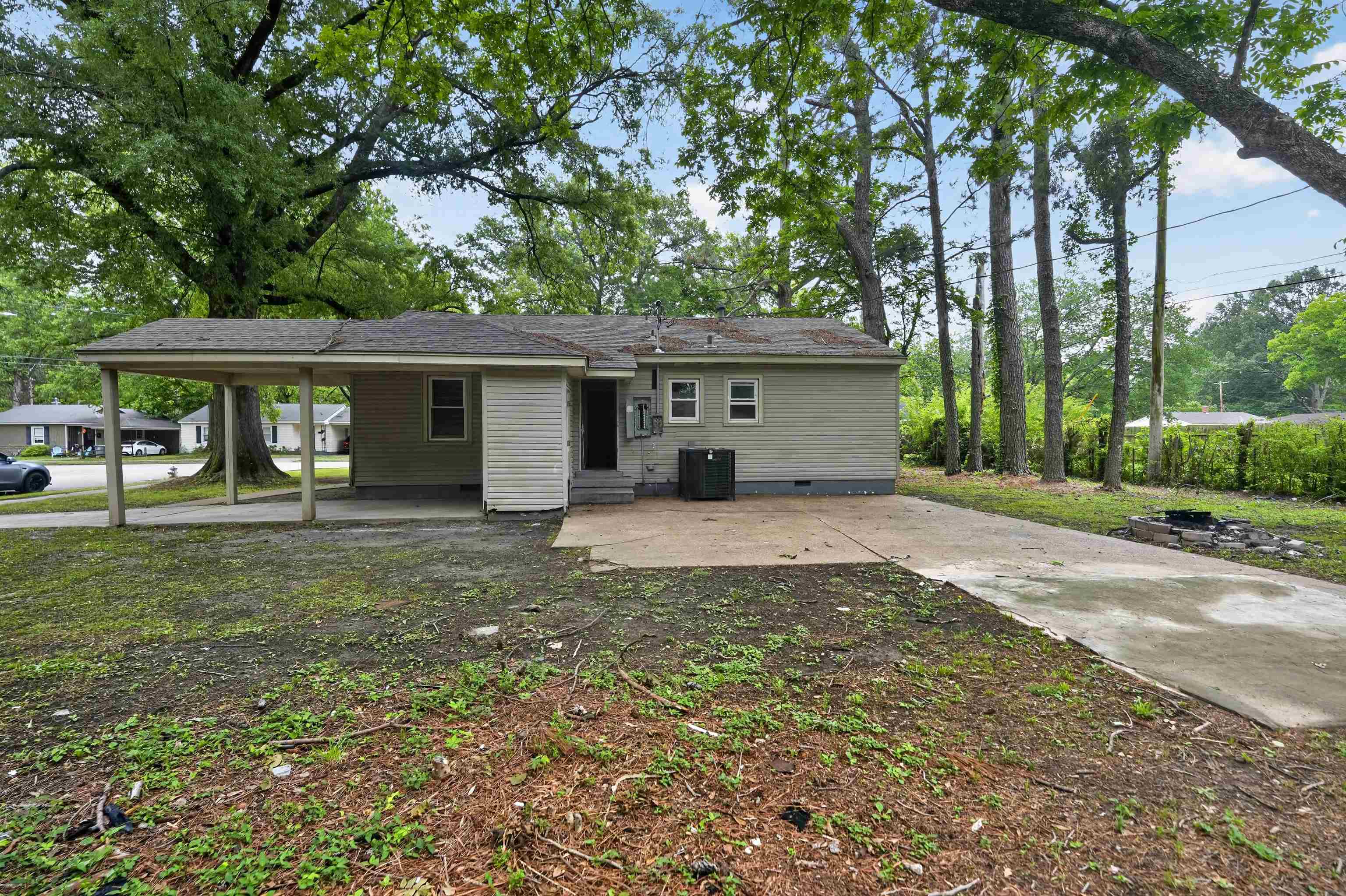 949 Sumter Street Memphis, TN 38122 - Photo 11 of 33 Exterior featuring light-colored siding, a covered carport, and a concrete patio
