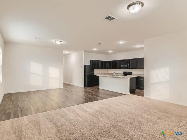 a view of kitchen with wooden floor