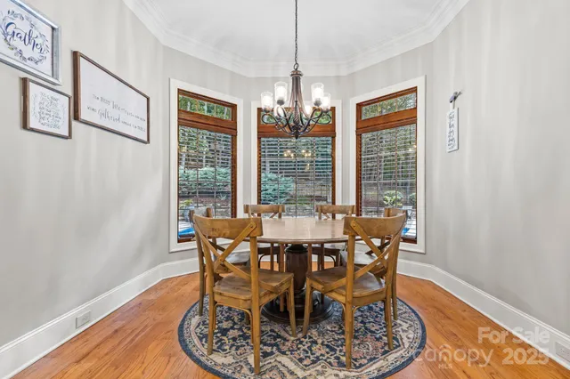 a view of a dining room with furniture wooden floor and chandelier