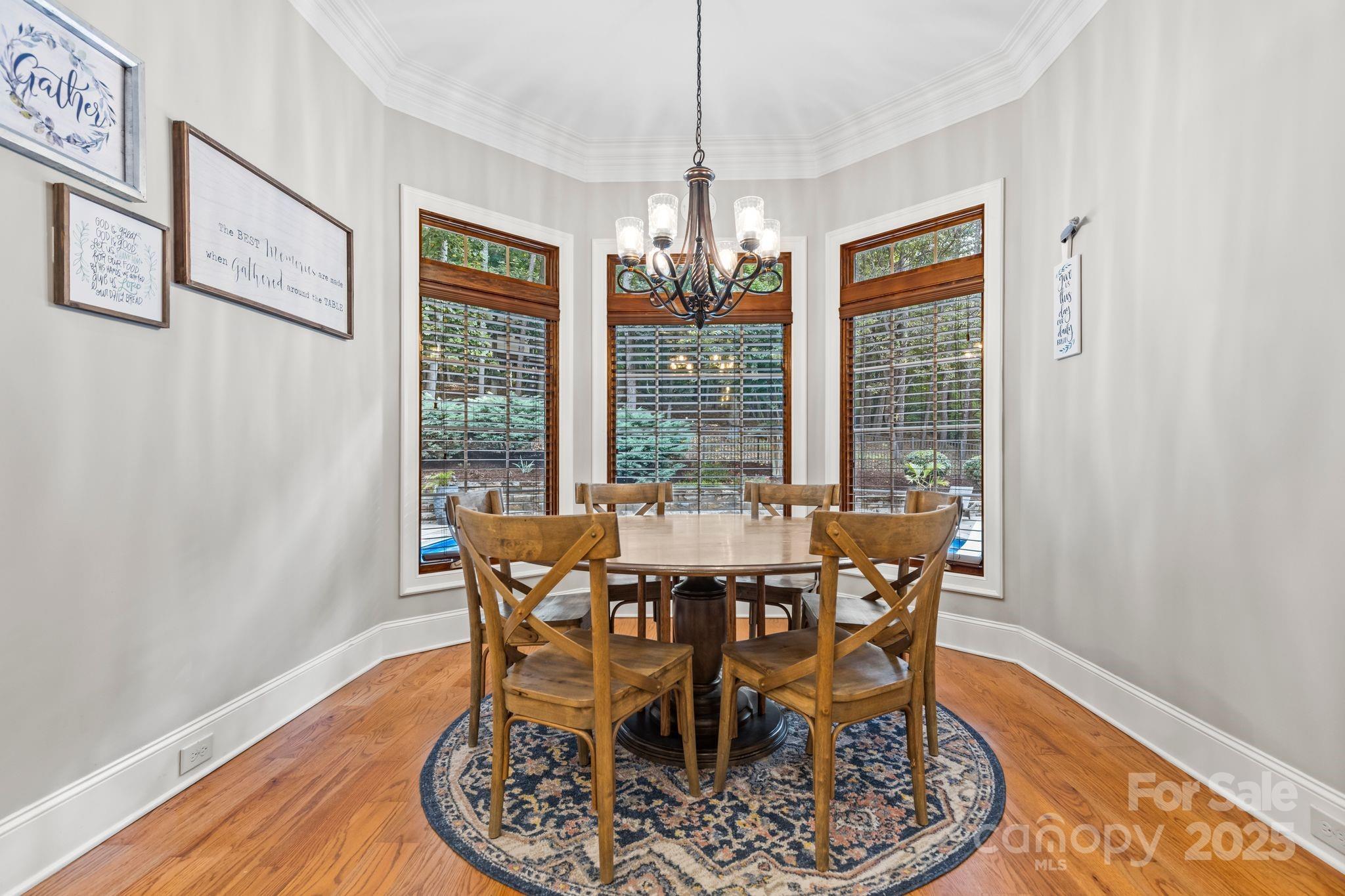 143 Greenbay Road Mooresville, NC 28117 - Photo 11 of 46 a view of a dining room with furniture wooden floor and chandelier