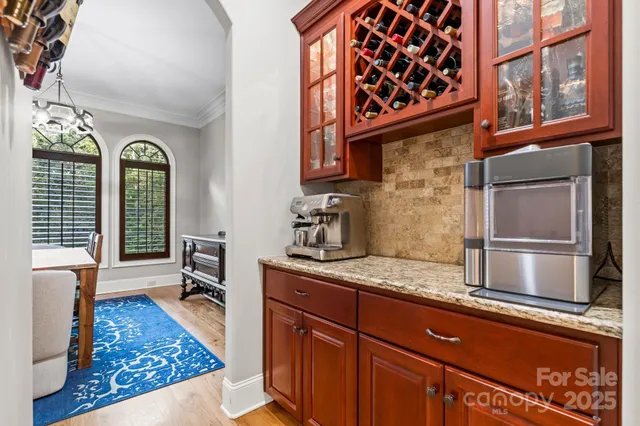 a kitchen with stainless steel appliances granite countertop a refrigerator and a stove
