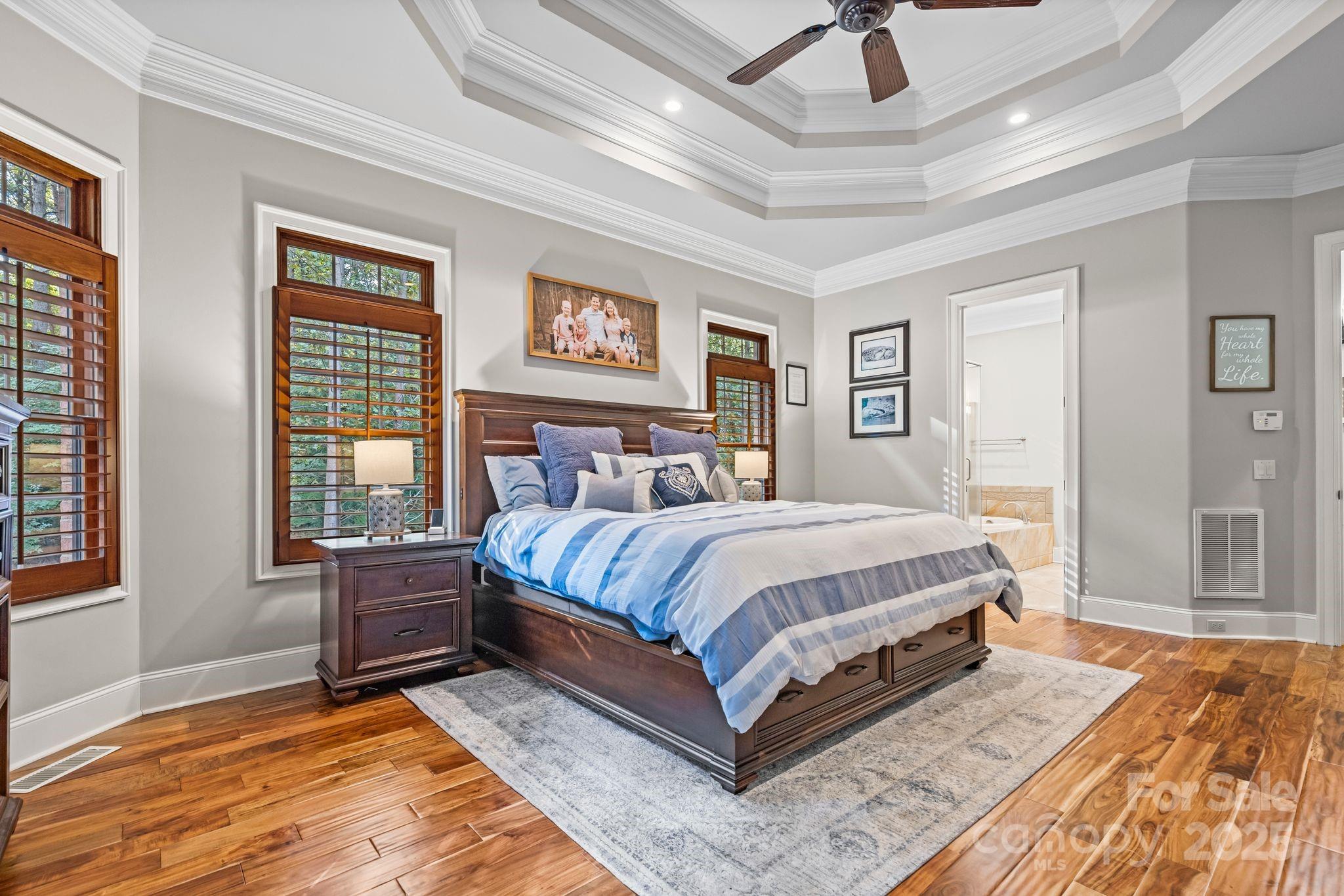 143 Greenbay Road Mooresville, NC 28117 - Photo 18 of 46 a spacious bedroom with a bed painting on wall and two windows