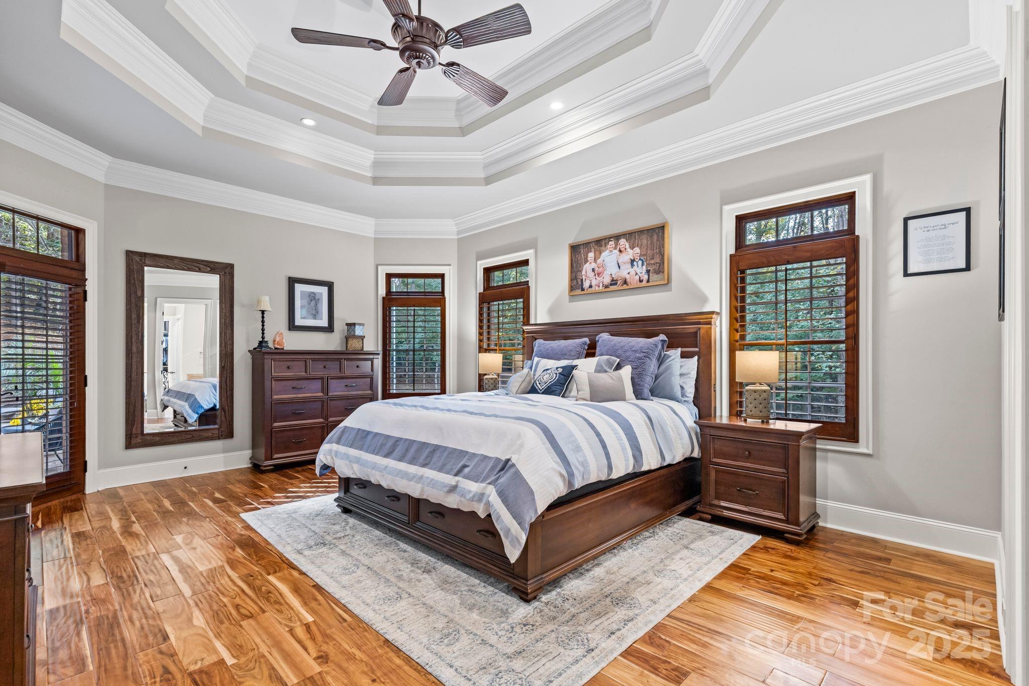 143 Greenbay Road Mooresville, NC 28117 - Photo 19 of 46 a bedroom with a large bed and a chandelier