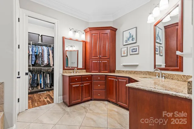 a spacious bathroom with a granite countertop sink and a mirror