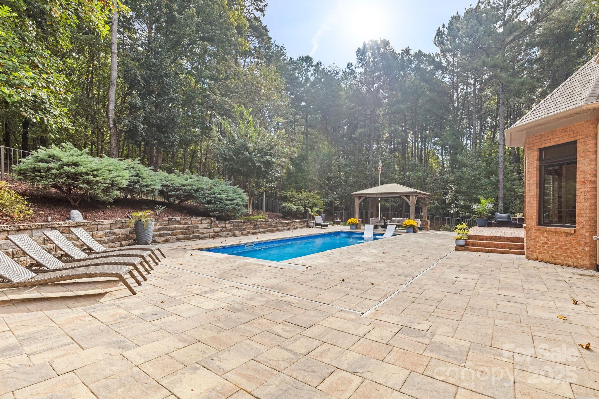 143 Greenbay Road Mooresville, NC 28117 - Photo 43 of 46 a view of a swimming pool with chair and tables