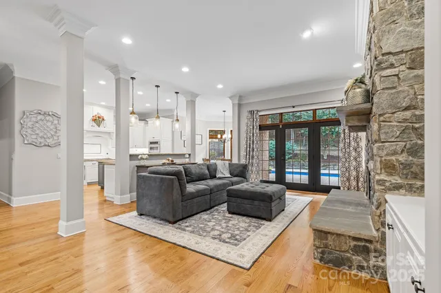 a living room with furniture rug and wooden floor