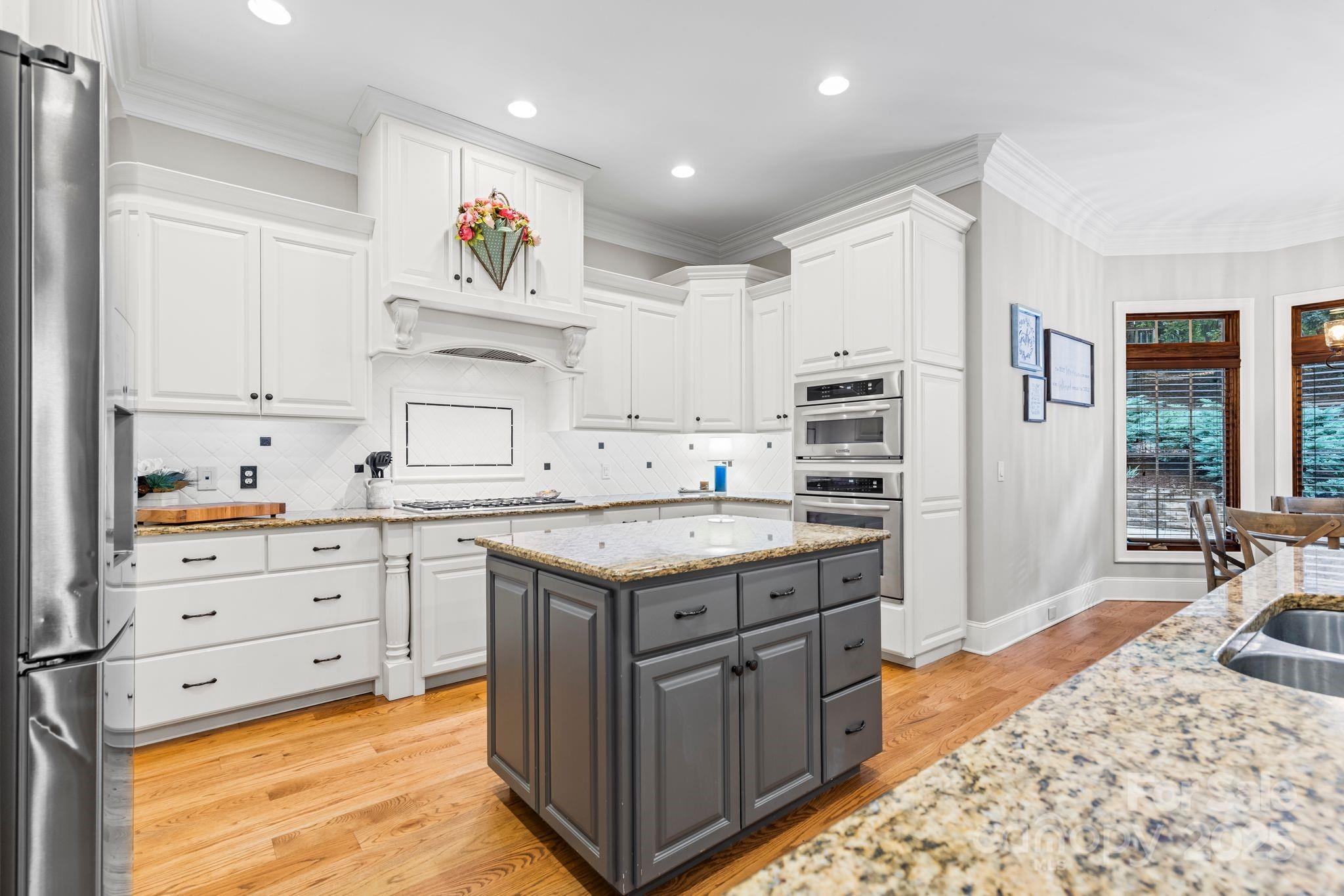 143 Greenbay Road Mooresville, NC 28117 - Photo 10 of 46 a kitchen that has a lot of cabinets in it and wooden floors