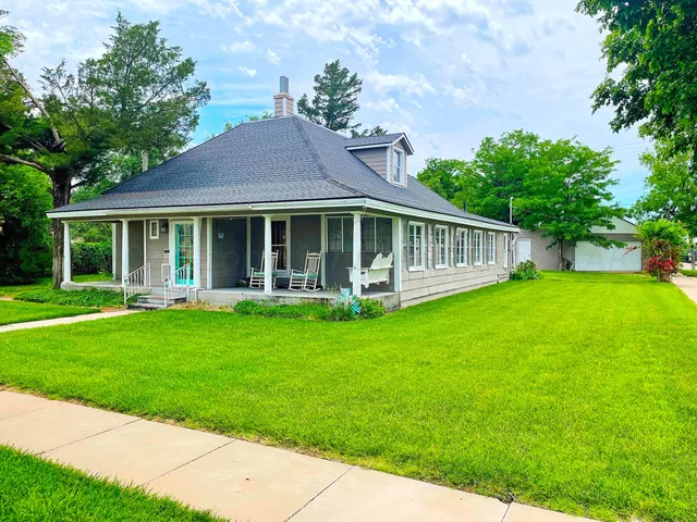 a front view of a house with a garden and porch