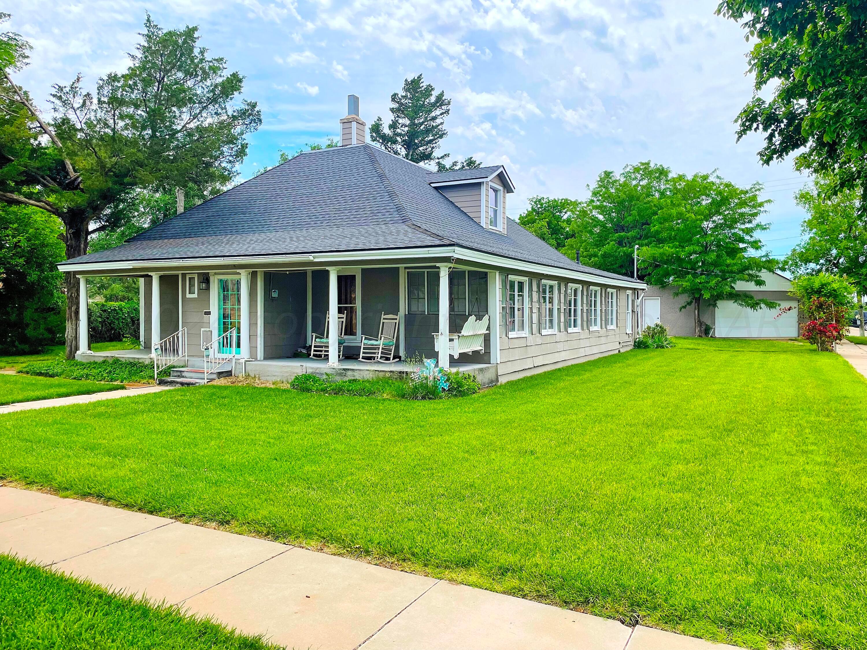 a front view of a house with a garden and porch