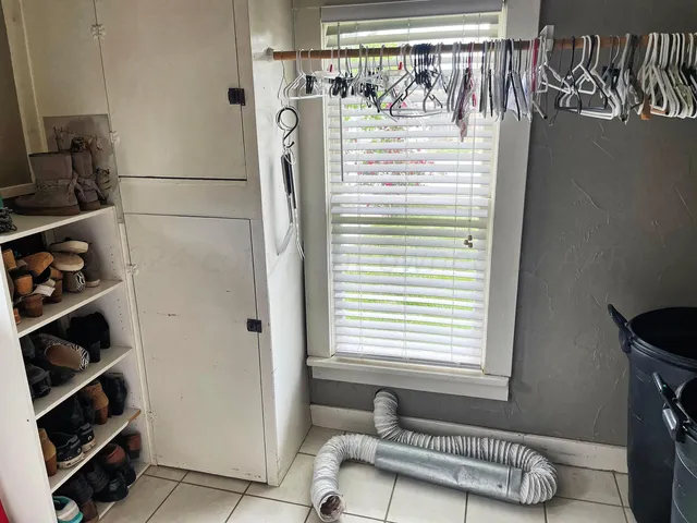 a bathroom with a window and a shower