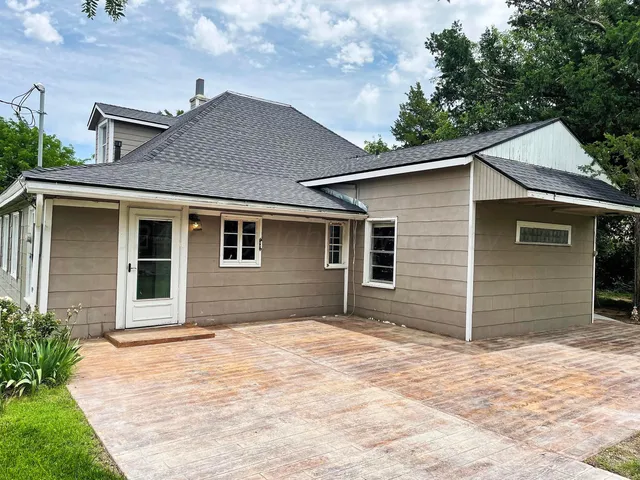 a house that has a tree in front of the house