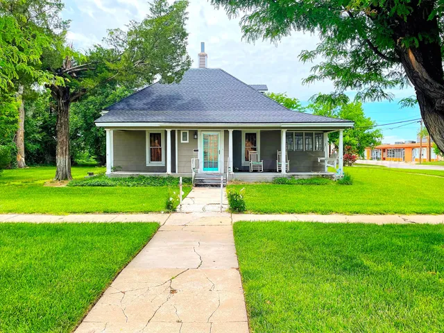 a front view of a house with yard and green space