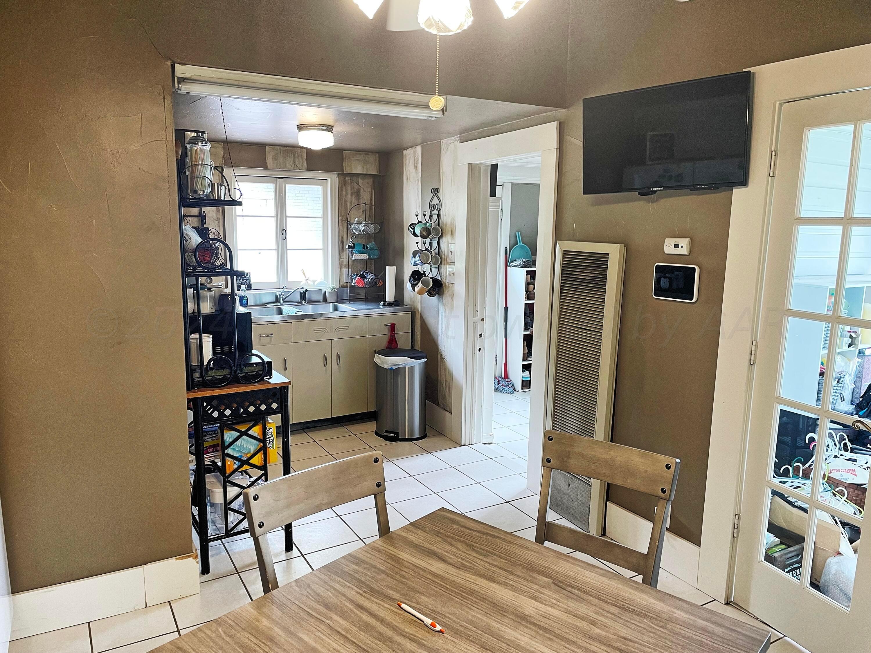 302 South Baylor Street Perryton, TX 79070 - Photo 6 of 21 a kitchen with stainless steel appliances a refrigerator and cabinets