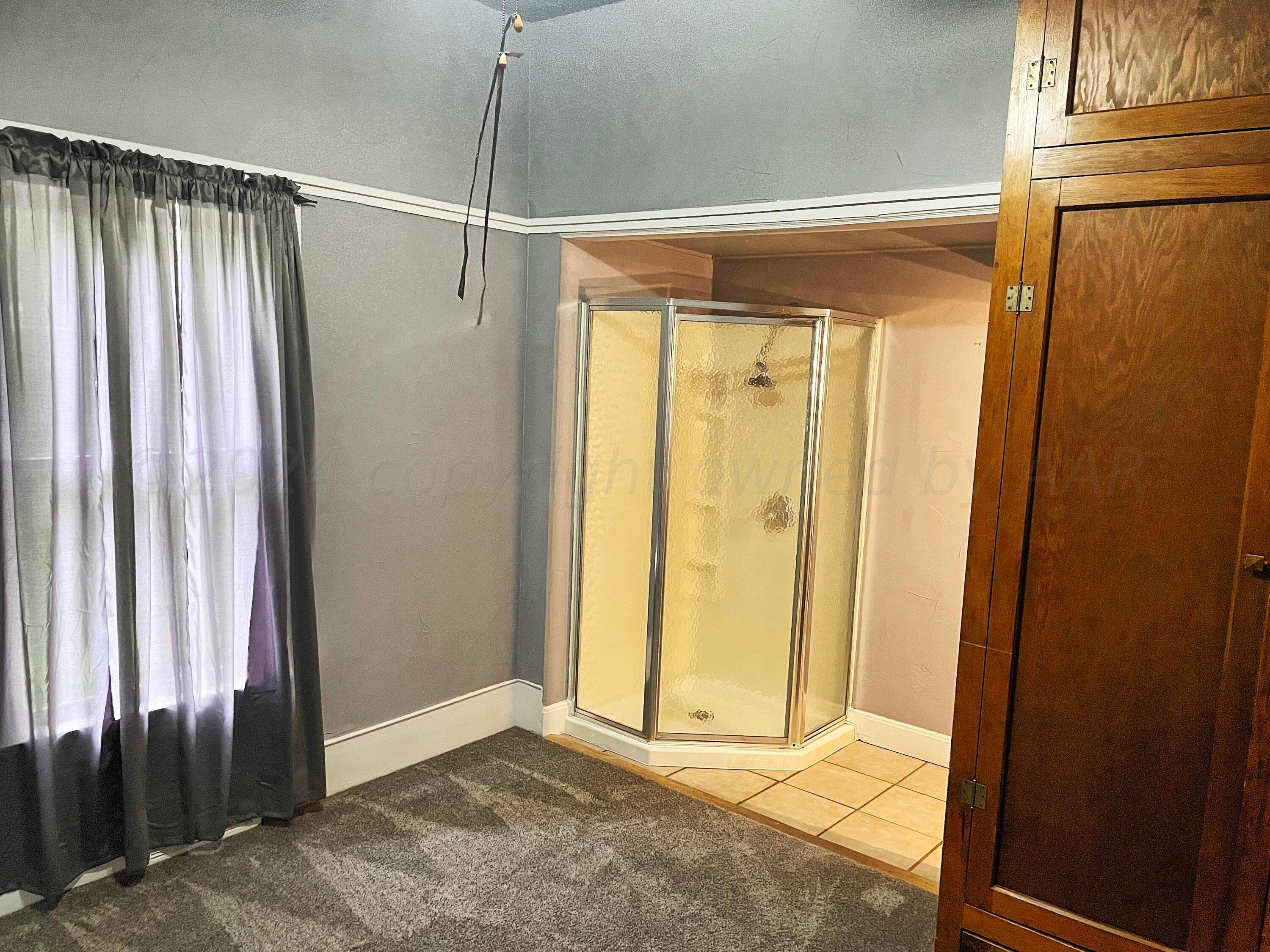 302 South Baylor Street Perryton, TX 79070 - Photo 8 of 21 a view of a bathroom with a glass door