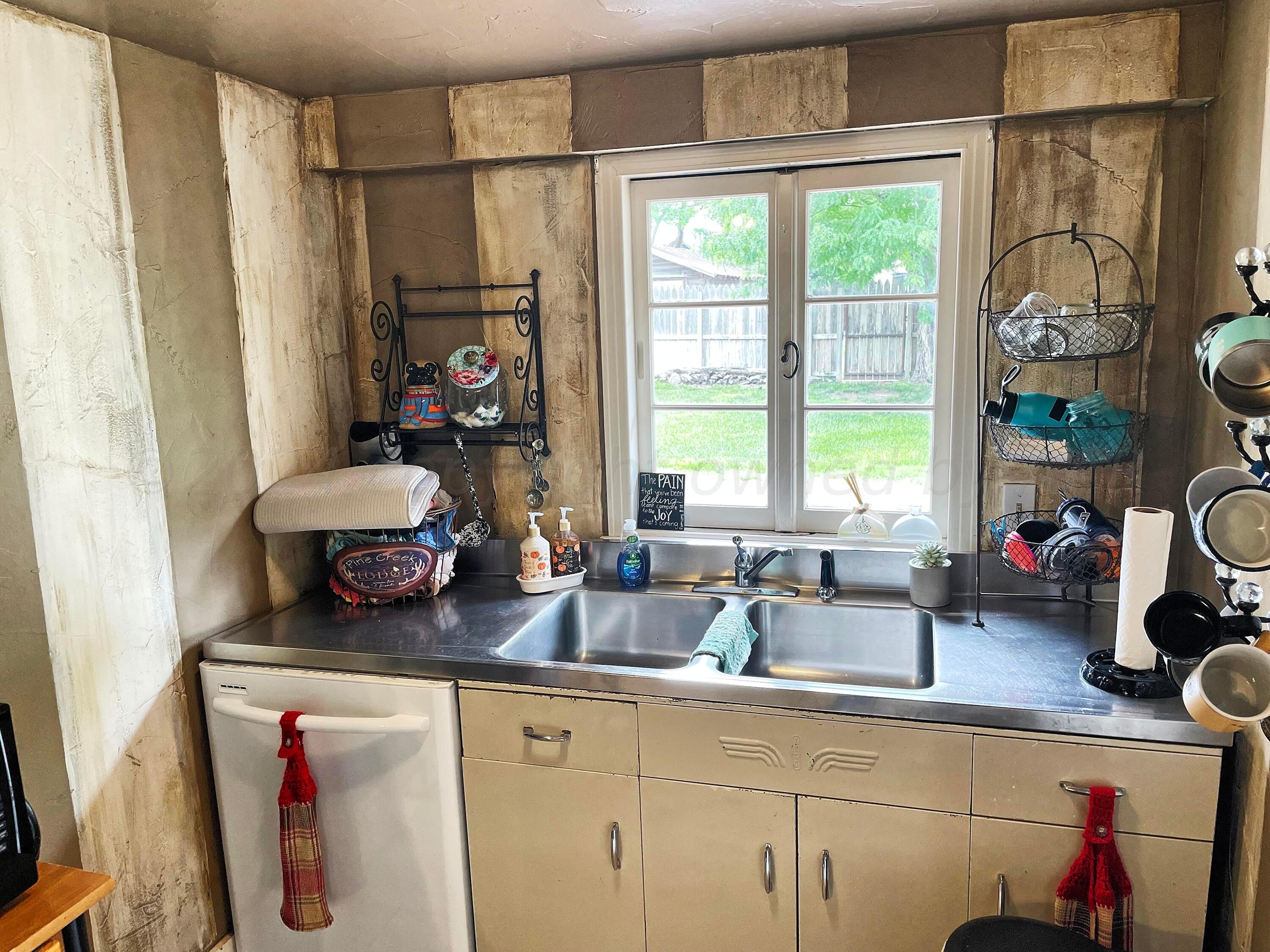 302 South Baylor Street Perryton, TX 79070 - Photo 10 of 21 a kitchen with sink refrigerator and window