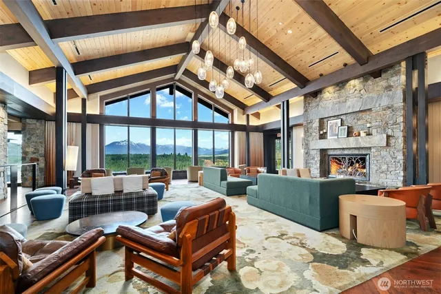 a living room with furniture a large window and chandelier