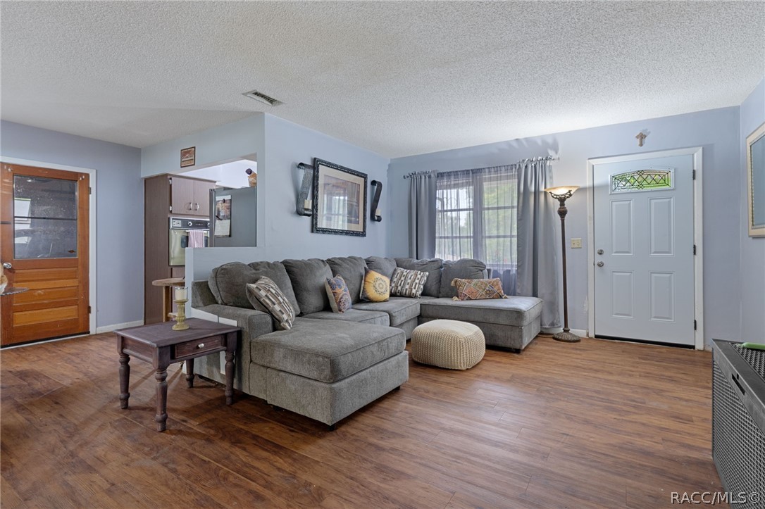 3355 South Highlands Avenue Inverness, FL 34452 - Photo 7 of 30 a living room with furniture and a wooden floor
