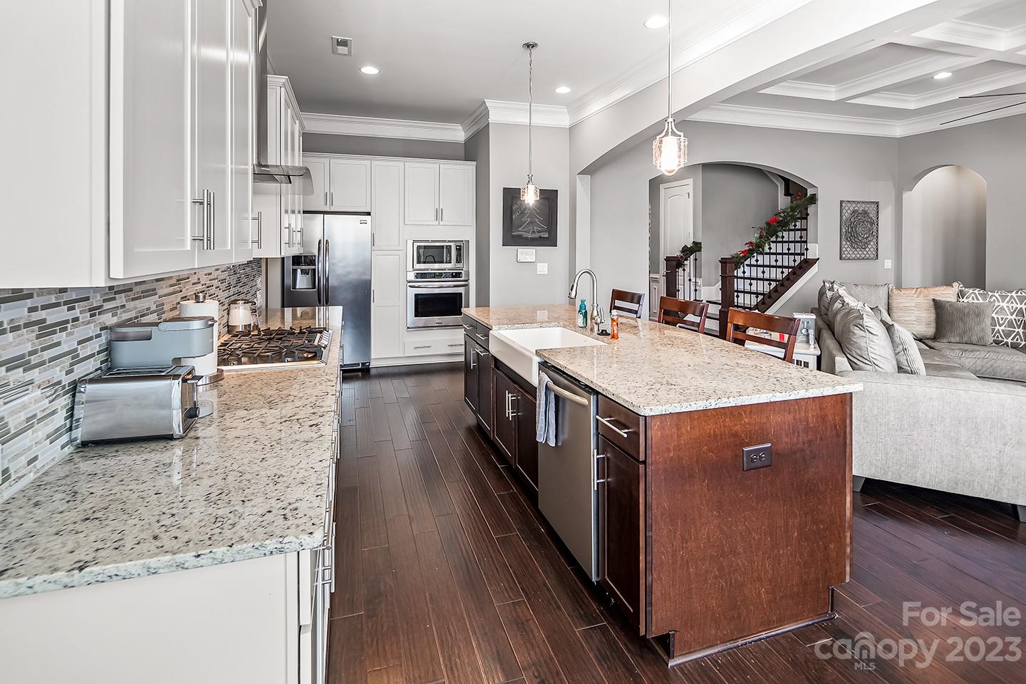 6004 Tremont Drive Indian Trail, NC 28079 - Photo 16 of 40 a large kitchen with stainless steel appliances kitchen island granite countertop a large counter top and sink