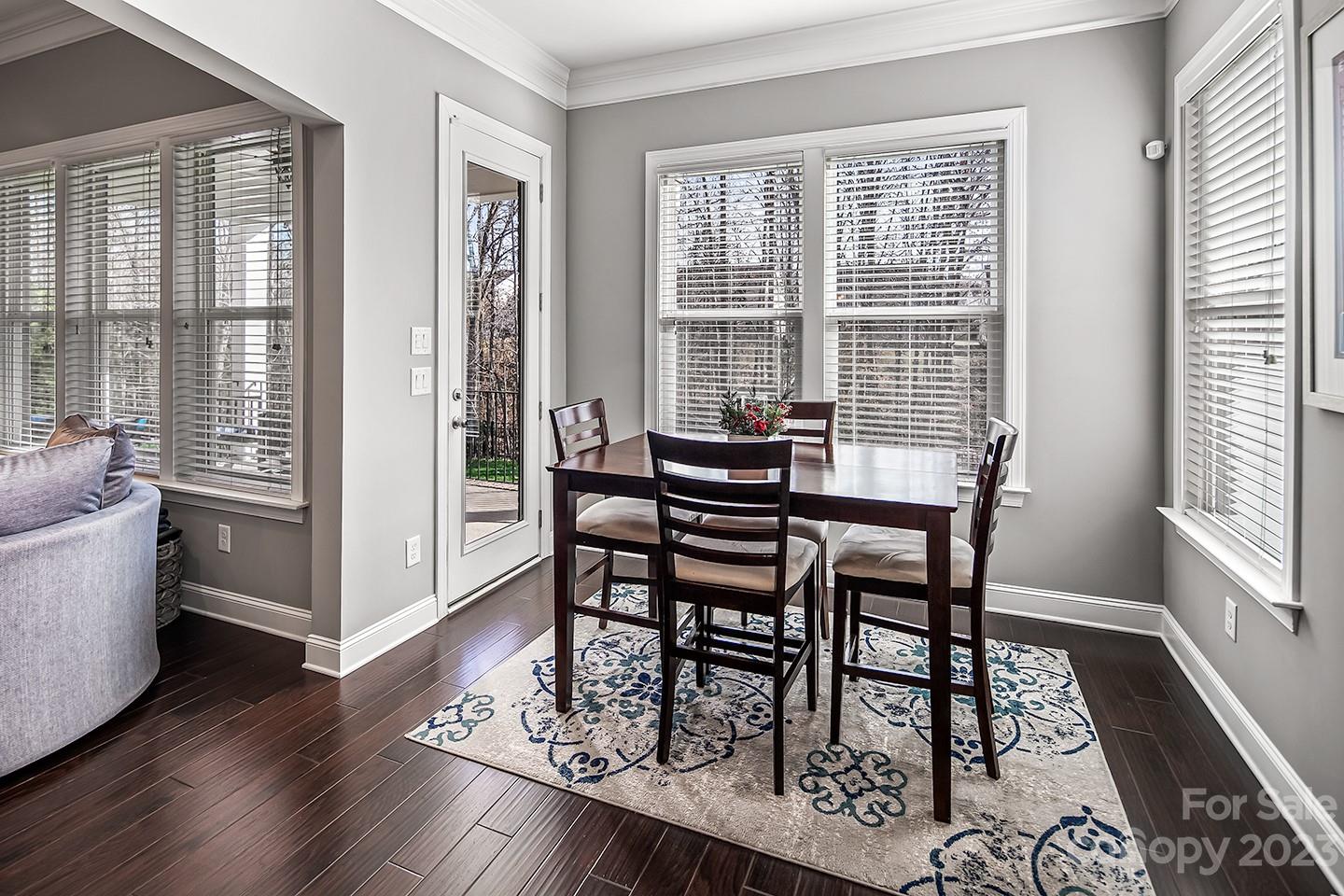 6004 Tremont Drive Indian Trail, NC 28079 - Photo 18 of 40 a view of a dining room with furniture wooden floor and a rug