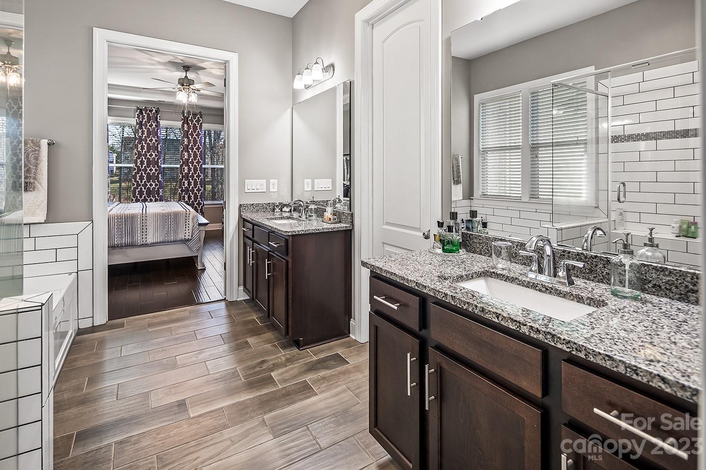 6004 Tremont Drive Indian Trail, NC 28079 - Photo 23 of 40 a spacious bathroom with a granite countertop sink a mirror and a bathtub