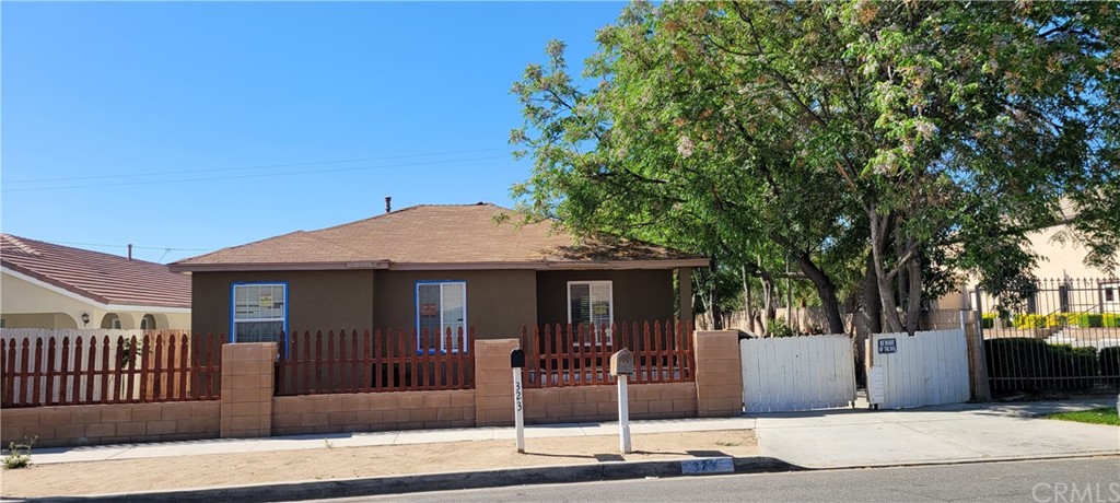323 East 5th Street Perris, CA 92570 - Photo 1 of 1 a front view of a house with a tree