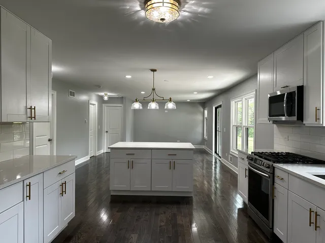 a bathroom with a sink a large mirror and a shower